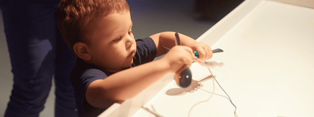157 Things to do in leicester: image shows a toddler interacting with an exhibit.